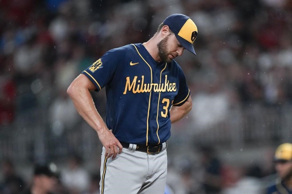 Milwaukee Brewers starting pitcher Adrian Houser waits on the mound for manager Craig Counsell to relieve him in the fifth inning of a baseball game against the Atlanta Braves, Friday, July 28, 2023, in Atlanta. (AP Photo/John Bazemore)