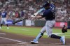 Tampa Bay Rays' Brandon Lowe hits a three-run home run against the Houston Astros during the first inning of a baseball game Friday, July 28, 2023, in Houston. (AP Photo/Kevin M. Cox)