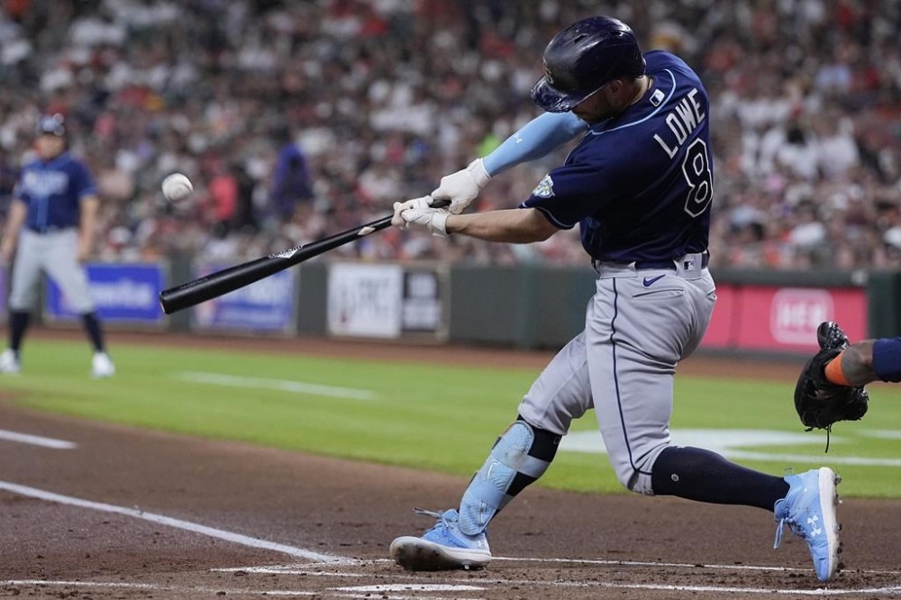 Tampa Bay Rays' Brandon Lowe hits a three-run home run against the Houston Astros during the first inning of a baseball game Friday, July 28, 2023, in Houston. (AP Photo/Kevin M. Cox)