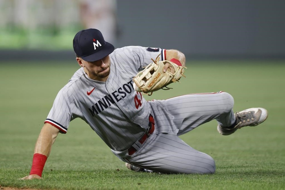 Minnesota Twins second baseman Edouard Julien fields a ground ball by Kansas City Royals' Kyle Isbel for an out during the seventh inning of a baseball game in Kansas City, Mo., Friday, July 28, 2023. (AP Photo/Colin E. Braley)