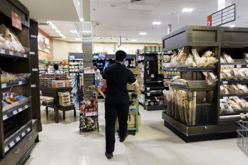 A worker walks around a Metro grocery store in Toronto, Tuesday, July 18, 2023. THE CANADIAN PRESS/Cole Burston