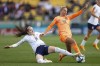 United States' Rose Lavelle, left, attempts a tackle on Netherlands' Jackie Groenen during the Women's World Cup Group E soccer match between the United States and the Netherlands in Wellington, New Zealand, Thursday, July 27, 2023. (AP Photo/Alysa Rubin)