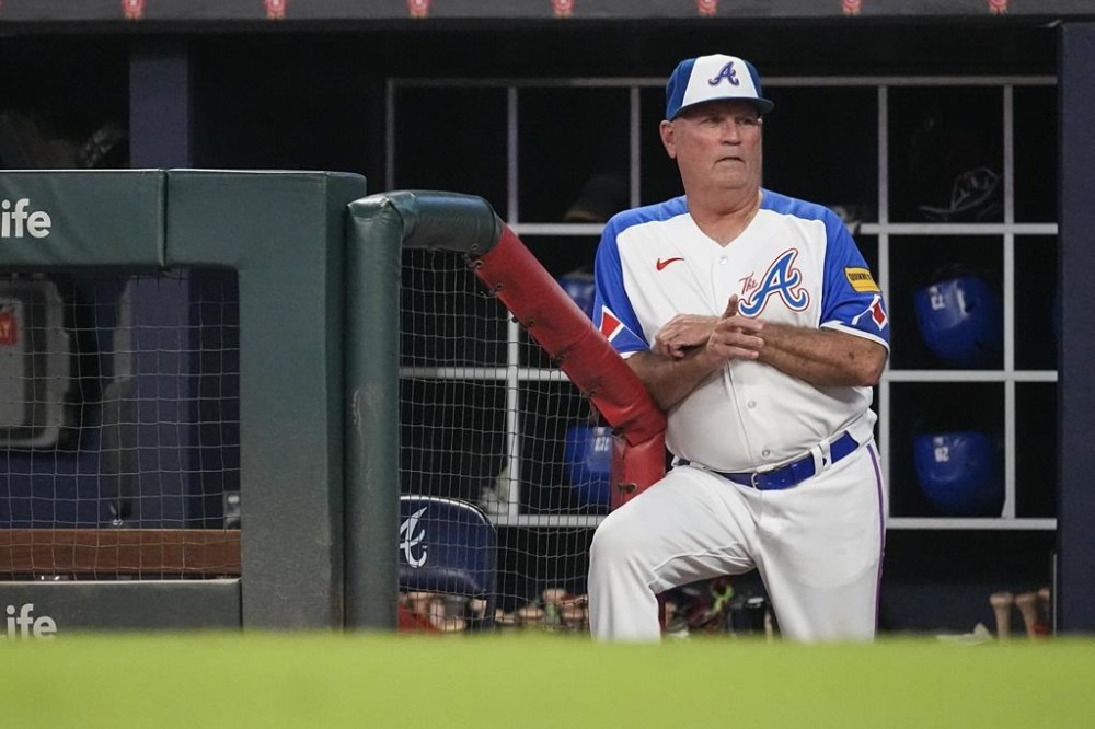 Atlanta Braves manager Brian Snitker watches from the dugout during the team's baseball game against the Milwaukee Brewers on Saturday, July 29, 2023, in Atlanta. (AP Photo/John Bazemore)