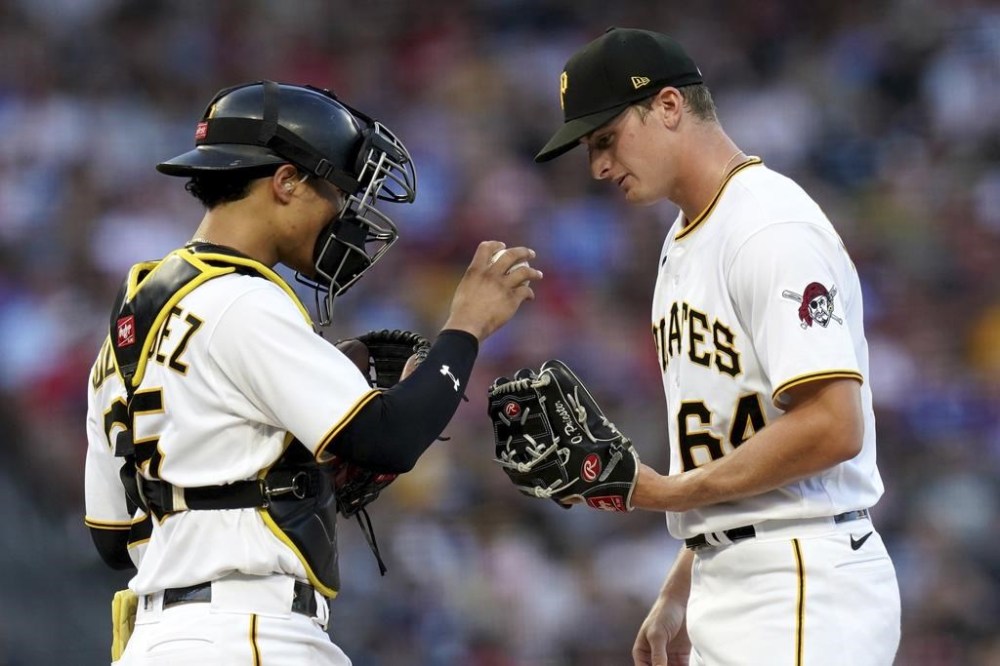 Pittsburgh Pirates catcher Endy Rodriguez talks with starting pitcher Quinn Priester during the fourth inning of the team's baseball game against the Philadelphia Phillies in Pittsburgh, Saturday, July 29, 2023. (AP Photo/Matt Freed)