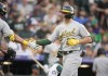 Oakland Athletics' JJ Bleday, left, congratulates Zack Gelof for a solo home run off Colorado Rockies starting pitcher Chris Flexen during the second inning of a baseball game Saturday, July 29, 2023, in Denver. (AP Photo/David Zalubowski)