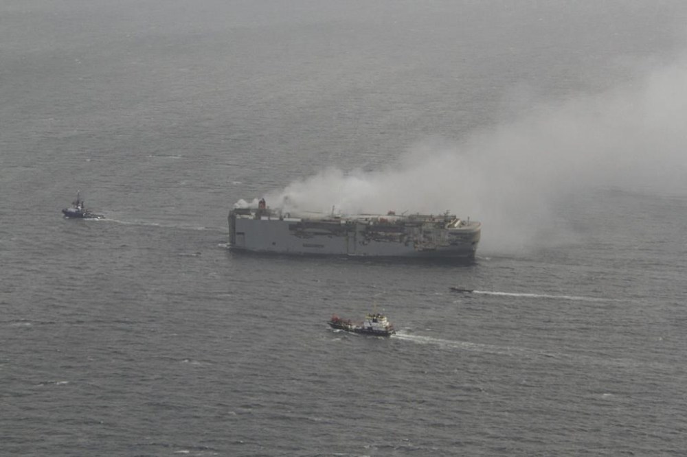 The freight ship, the Fremantle Highway, in the North Sea, Sunday July 30, 2023. Salvage crews began towing a burning cargo ship loaded with thousands of new cars to a temporary anchorage off the northern Dutch coast on Sunday after smoke from the stricken vessel eased, authorities said. (Kustwacht Nederland/Coast Guard Netherlands via AP)