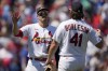 St. Louis Cardinals' Nolan Arenado and Alec Burleson (41) celebrate a 3-0 victory over the Chicago Cubs in a baseball game Sunday, July 30, 2023, in St. Louis. (AP Photo/Jeff Roberson)