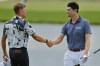 Vincent Norrman, left, shakes hands with Beau Hossler, right, after they finished their fourth round at the 3M Open golf tournament at the Tournament Players Club, Sunday, July 30, 2023, in Blaine, Minn. (AP Photo/Bruce Kluckhohn)