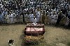 Relatives and mourners attend the funeral prayer of victims who were killed in Sunday's suicide bomber attack in the Bajur district of Khyber Pakhtunkhwa, Pakistan, Monday, July 31, 2023. Pakistan held funerals on Monday for victims of a massive suicide bombing that targeted a rally of a pro-Taliban cleric the previous day. (AP Photo/Mohammad Sajjad)