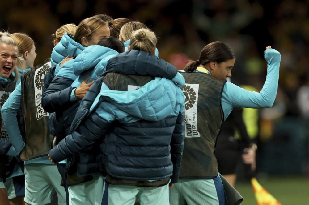 Australia's Sam Kerr, right, celebrates after teammate Hayley Raso scored their second goal during the Women's World Cup Group B soccer match between Australia and Canada in Melbourne, Australia, Monday, July 31, 2023. (AP Photo/Hamish Blair)