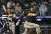 San Diego Padres' Juan Soto follows the flight of his single against Colorado Rockies starting pitcher Austin Gomber in the sixth inning of a baseball game Monday, July 31, 2023, in Denver. (AP Photo/David Zalubowski)