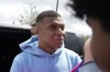 PSG's Kylian Mbappe meets fans as he leaves the Paris Saint-Germain training complex, Friday, July 28, 2023 in Poissy, outside Paris. Speculation is mounting as to where Mbappé will play his first game of the season. (AP Photo/Lewis Joly)