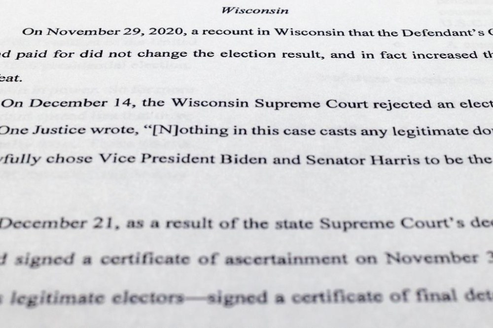 The indictment against former President Donald Trump charging him by the Justice Department for his efforts to overturn the results of the 2020 presidential election is photographed Tuesday, Aug. 1, 2023, in Washington. (AP Photo/Jon Elswick)