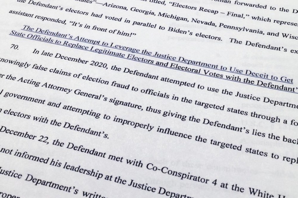 The indictment against former President Donald Trump charging him by the Justice Department for his efforts to overturn the results of the 2020 presidential election is photographed Tuesday, Aug. 1, 2023, in Washington. (AP Photo/Jon Elswick)