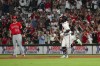 Atlanta Braves' Michael Harris II (23) gestures as he runs past Los Angeles Angels first baseman C.J. Cron (25) after hitting a home run in the seventh inning of a baseball game Tuesday, Aug. 1, 2023, in Atlanta. (AP Photo/John Bazemore)