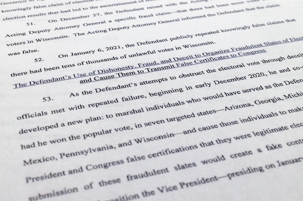 The indictment against former President Donald Trump charging him by the Justice Department for his efforts to overturn the results of the 2020 presidential election is photographed Tuesday, Aug. 1, 2023, in Washington. (AP Photo/Jon Elswick)
