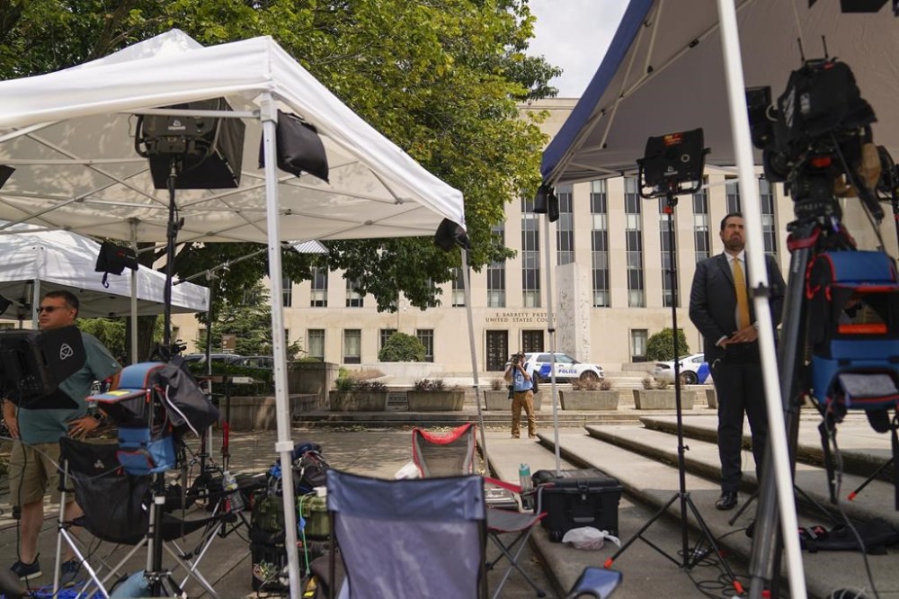 Members of the media outside E. Barrett Prettyman US Federal Courthouse Wednesday, Aug. 2, 2023, in Washington. Former President Donald Trump is due in court on Thursday, the first step in a legal process that will play out in a courthouse between the White House he once controlled and the Capitol his supporters once stormed. (AP Photo/Pablo Martinez Monsivais)