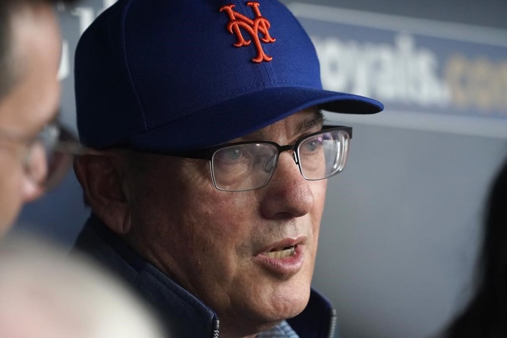 New York Mets owner Steve Cohen talks to the media in the dugout before a baseball game against the Kansas City Royals Wednesday, Aug. 2, 2023, in Kansas City, Mo. (AP Photo/Charlie Riedel)