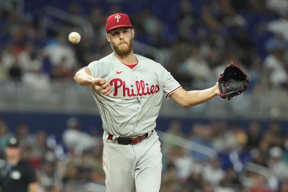 CORRECTS THAT ARRAEZ GROUNDED OUT; HE DID NOT HAVE A HIT - Philadelphia Phillies starting pitcher Zack Wheeler throws to first base for the out on a grounder by by Miami Marlins' Luis Arraez during the third inning of a baseball game, Wednesday, Aug. 2, 2023, in Miami. (AP Photo/Marta Lavandier)