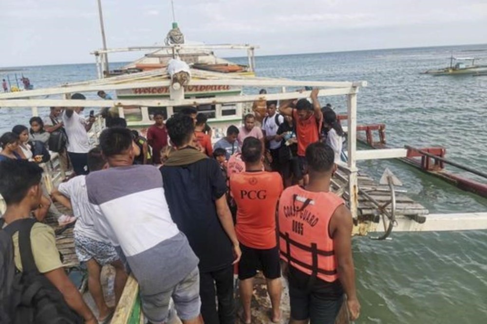 In this handout photo provided by the Philippine Coast Guard, rescued passengers arrive on a boat in Polillo, Quezon province, northeastern Philippines on Thursday Aug. 3, 2023. The Philippine coast guard rescued all 67 people from a ferry boat that struck a floating object and took on water Thursday off a northeastern province, in the second ferry accident to hit the country in a week, officials said. (Philippine Coast Guard via AP)