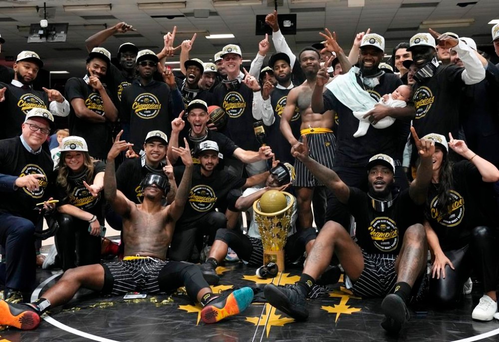 Hamilton Honey Badgers players and team members celebrate with the championship trophy after defeating the Scarborough Shooting Stars in the Canadian Elite Basketball League championship final, Sunday, Aug. 14, 2022 in Ottawa. The Manitoba government is promising up to $1 million dollars to support a bid by the Winnipeg Sea Bears to host the league championship in 2025. THE CANADIAN PRESS/Adrian Wyld