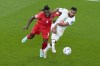 Canada's Sam Adekugbe and Morocco's Sofiane Boufal vie for the ball during the World Cup group F soccer match between Canada and Morocco at the Al Thumama Stadium in Doha , Qatar, Thursday, Dec. 1, 2022. The Vancouver Whitecaps acquired the Canadian defender via transfer from Turkish side Hatayspor on Thursday. THE CANADIAN PRESS/AP-Alessandra Tarantino