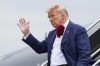 Former President Donald Trump waves as he steps off his plane at Ronald Reagan Washington National Airport, Thursday, Aug. 3, 2023, in Arlington, Va., as he heads to Washington to face a judge on federal conspiracy charges alleging Trump conspired to subvert the 2020 election. (AP Photo/Alex Brandon)