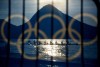 FILE - Rowers are seen through a screen decorated with the Olympic rings as they practice at the rowing venue in Lagoa at the 2016 Summer Olympics in Rio de Janeiro, Brazil, on Aug. 7, 2016. British Rowing has announced it will ban transgender women from competing in women's events at its competitions. The governing body said Thursday, Aug. 3, 2023, that only individuals “who are assigned female at birth” will be eligible to compete in its women's races and represent Britain internationally. (AP Photo/David Goldman, File)