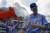 Kansas City Royals starting pitcher Brady Singer (51) gets doused by Bobby Witt Jr. after their baseball game against the New York Mets Thursday, Aug. 3, 2023, in Kansas City, Mo. The Royals won 9-2. (AP Photo/Charlie Riedel)
