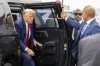 Former President Donald Trump exits his vehicle to walk over to speak with reporters before he boards his plane at Ronald Reagan Washington National Airport, Thursday, Aug. 3, 2023, in Arlington, Va., after facing a judge on federal conspiracy charges that allege he conspired to subvert the 2020 election. At right his valet Walt Nauta. (AP Photo/Alex Brandon)