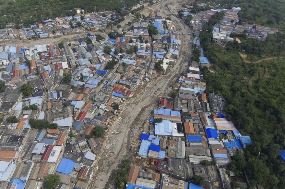 An aerial view of the flood devastated Nanxinfang village on the outskirts of Beijing, Friday, Aug. 4, 2023. Heavy rain and high water levels on rivers in northeastern China were threatening cities downstream on Friday, prompting the evacuation of thousands, although the country appears to have averted the worst effects of the typhoon season battering parts of east Asia. (AP Photo/Ng Han Guan)