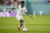 FILE - Yunus Musah of the United States dribbles the ball during their World Cup soccer match against the Netherlands, at the Khalifa International Stadium in Doha, Qatar, Saturday, Dec. 3, 2022. Musah is following United States teammate Christian Pulisic to American-owned AC Milan. Musah, who was born in New York but grew up in Italy and England, signed a five-year contract with the Rossoneri on Friday, Aug. 4, 2023 following a transfer from Valencia. (AP Photo/Ashley Landis, file)