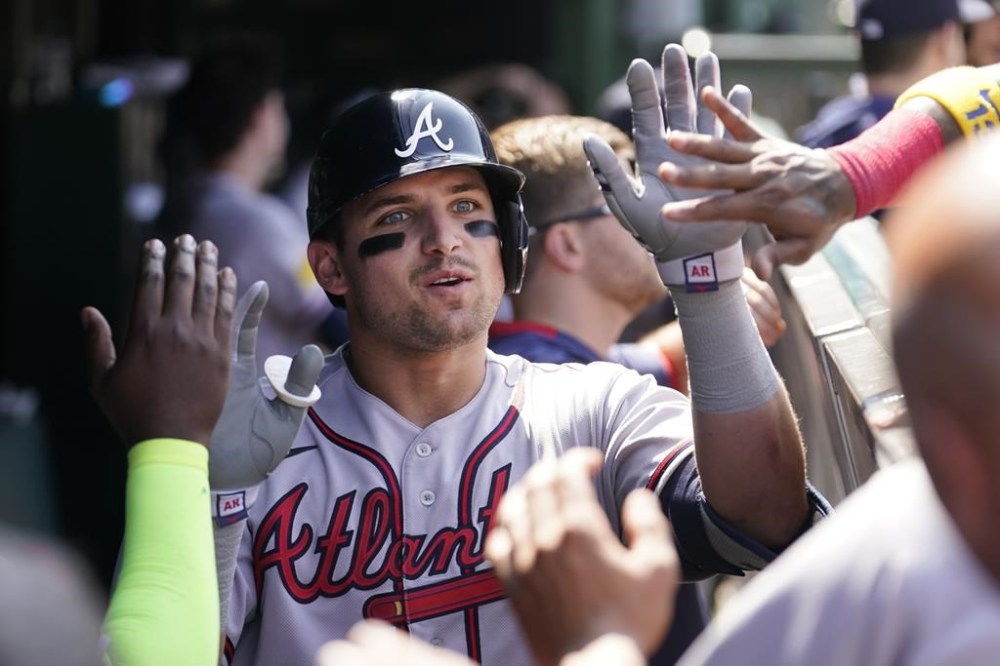 Atlanta Braves' Austin Riley celebrates in the dugout after his home run during the seventh inning of a baseball game against the Chicago Cubs, Friday, Aug. 4, 2023, in Chicago. (AP Photo/Charles Rex Arbogast)