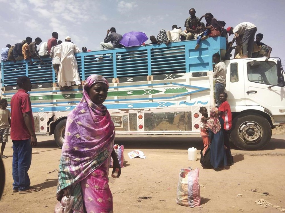 FILE - People board a truck as they leave Khartoum, Sudan, on June 19, 2023. A leading human rights group called Friday Aug.4, 2023 on the United States and the United Nations to impose further sanctions on the Sudanese individuals
