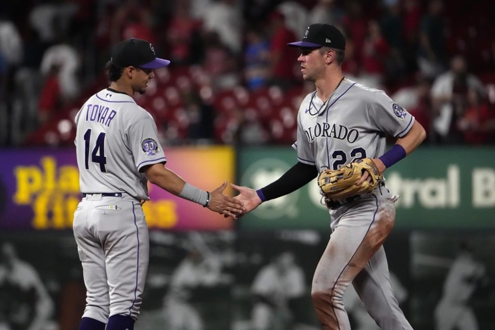 Colorado Rockies' Nolan Jones (22) and Ezequiel Tovar (14) celebrate a 9-4 victory over the St. Louis Cardinals in a baseball game Friday, Aug. 4, 2023, in St. Louis. (AP Photo/Jeff Roberson)