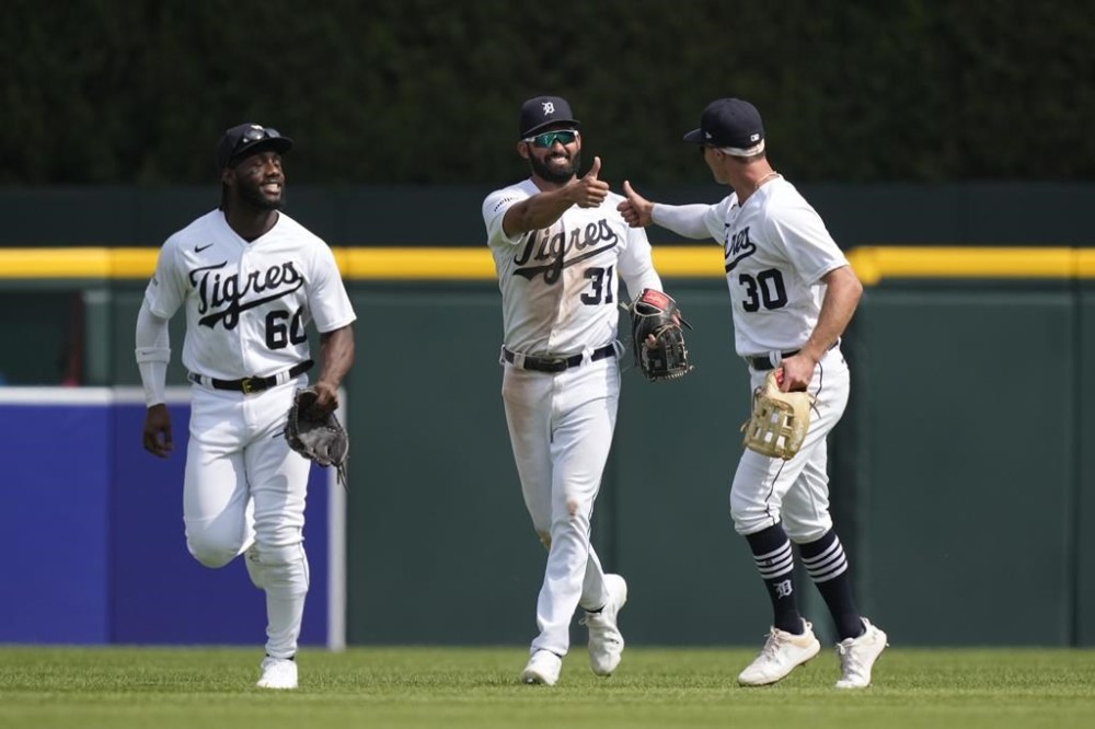 Detroit Tigers left fielder Akil Baddoo (60), center fielder Riley Greene (31) and right fielder Kerry Carpenter (30) celebrate the team's win over the Tampa Bay Rays after the ninth inning of a baseball game, Saturday, Aug. 5, 2023, in Detroit. (AP Photo/Carlos Osorio)