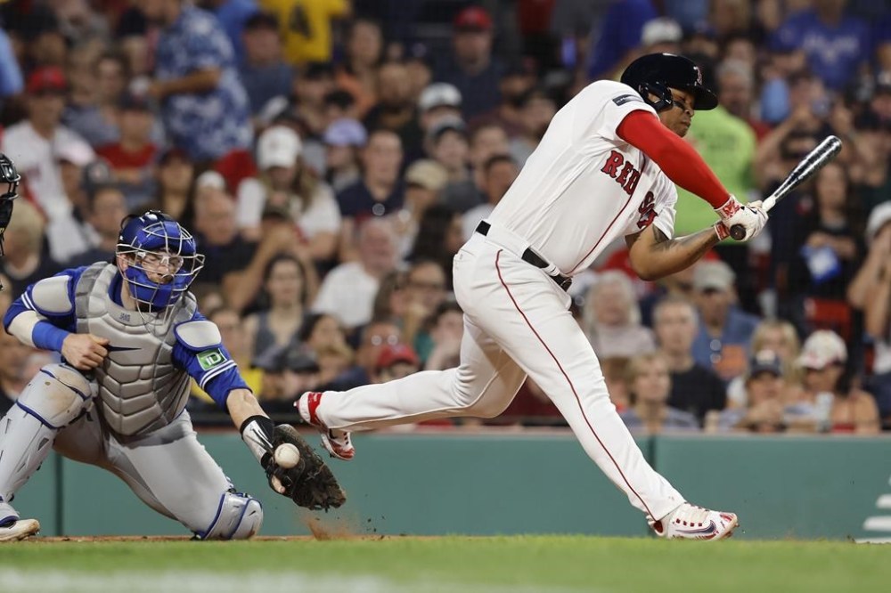 Boston Red Sox's Rafael Devers is hit by a pitch in front of Toronto Blue Jays catcher Danny Jansen during the fourth inning of a baseball game Friday, Aug. 4, 2023, in Boston. THE CANADIAN PRESS/AP-Michael Dwyer