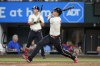 Texas Rangers' Corey Seager follows through on a two-run home run in the fifth inning of a baseball game against the Miami Marlins, Saturday, Aug. 5, 2023, in Arlington, Texas. Marcus Semien also scored on the shot. (AP Photo/Tony Gutierrez)
