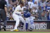 San Diego Padres third baseman Manny Machado, above, helps Los Angeles Dodgers' Mookie Betts up after Betts hit a double and advanced to third off a fielding error by San Diego Padres left fielder Juan Soto during the fifth inning of a baseball game Saturday, Aug. 5, 2023, in San Diego. (AP Photo/Gregory Bull)