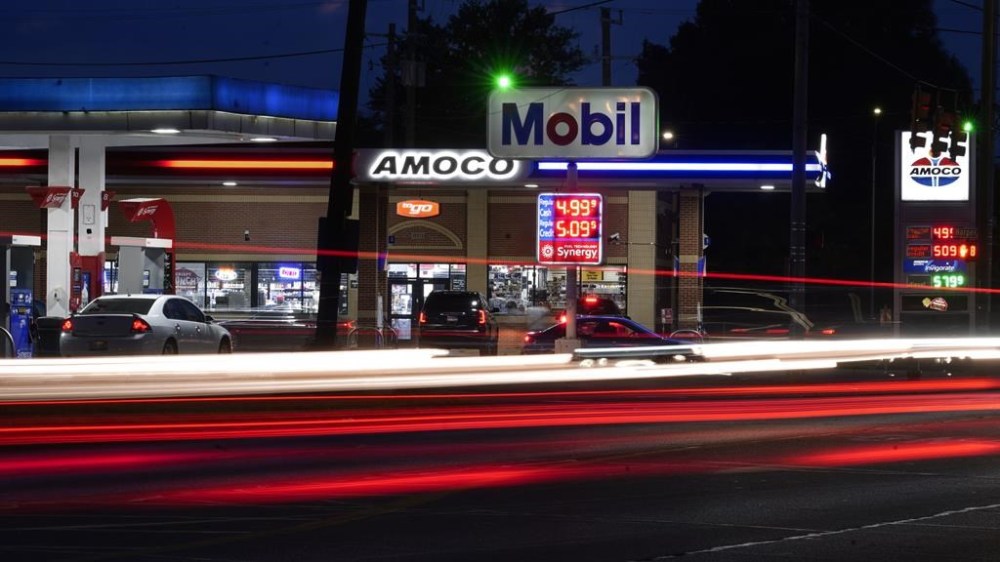 File - Motorists stop for fuel at gas stations in Detroit, Tuesday, July 5, 2022. If the auto industry boosts electric vehicle sales to the level the Environmental Protection Agency recommends, any reduction in pollution could prove more modest than the agency expects. The Associated Press has estimated that nearly 80% of vehicles being driven in the U.S. — more than 200 million — would still run on gasoline or diesel fuel. (AP Photo/Paul Sancya, File)