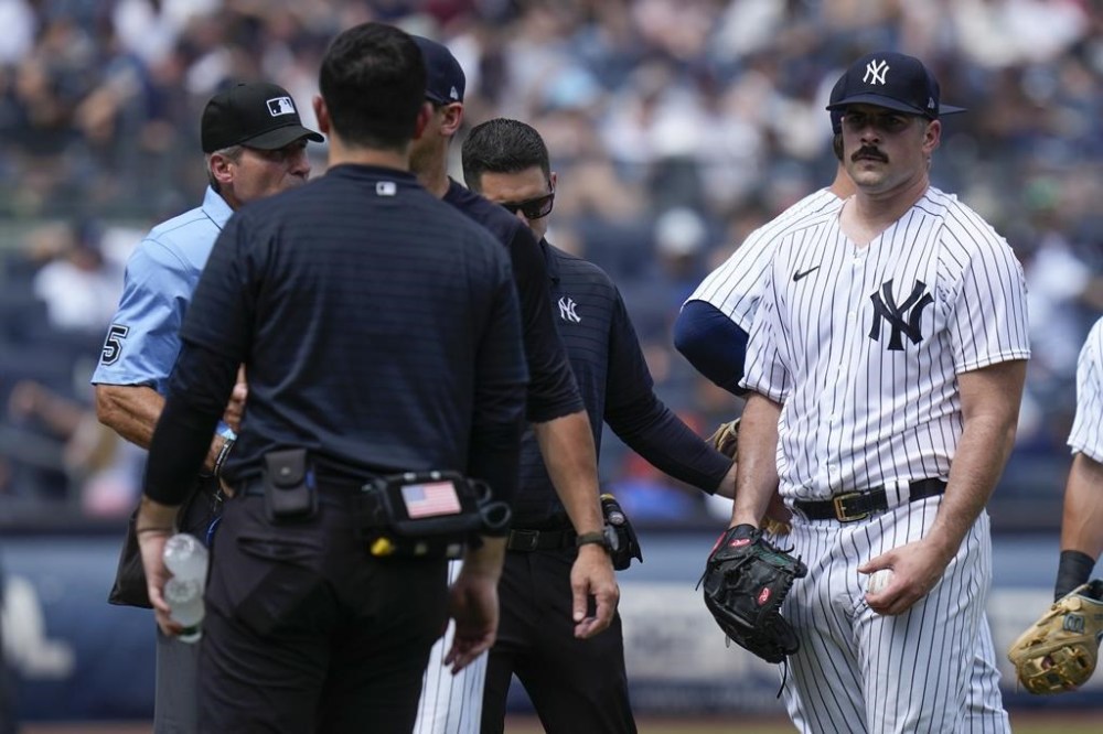 New York Yankees' Carlos Rodon, right, reacts as he is pulled during the third inning of a baseball game against the Houston Astros at Yankee Stadium, Sunday, Aug. 6, 2023, in New York. (AP Photo/Seth Wenig)