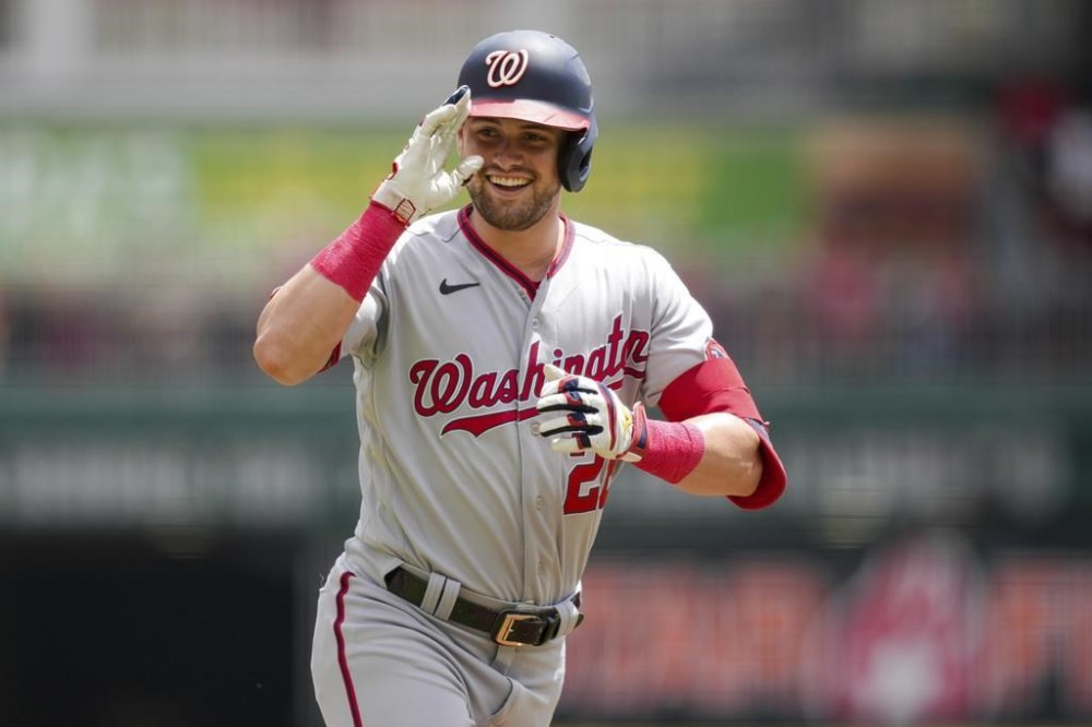 Washington Nationals' Lane Thomas gestures to the dugout after hitting a solo home run during the first inning of a baseball game against the Cincinnati Reds in Cincinnati, Sunday, Aug. 6, 2022. (AP Photo/Aaron Doster)