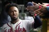 Atlanta Braves' Ozzie Albies celebrates with teammates after scoring on a one-run single by Matt Olson during the fifth inning of a baseball game against the Chicago Cubs in Chicago, Sunday, Aug. 6, 2023. (AP Photo/Nam Y. Huh)