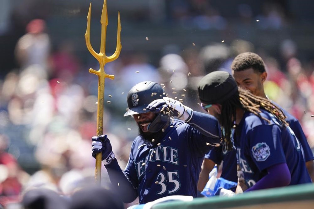 Seattle Mariners designated hitter Teoscar Hernandez (35) celebrates after hitting a home run during the seventh inning of a baseball game against the Los Angeles Angels in Anaheim, Calif., Sunday, Aug. 6, 2023. (AP Photo/Ashley Landis)