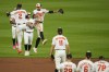Baltimore Orioles shortstop Gunnar Henderson (2) and left fielder Colton Cowser (17) celebrate with teammates after defeating the New York Mets 7-3 during a baseball game, Saturday, Aug. 5, 2023, in Baltimore. (AP Photo/Julio Cortez)