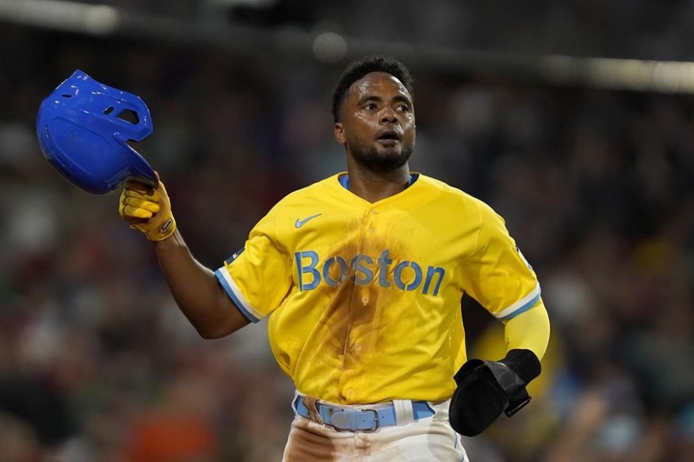 Boston Red Sox's Pablo Reyes returns to the dugout after scoring on a double hit by Connor Wong in the fifth inning of a baseball game against the Kansas City Royals, Monday, Aug. 7, 2023, in Boston. (AP Photo/Steven Senne)