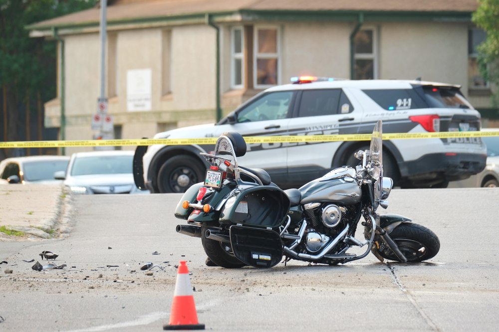 MIKE DEAL / WINNIPEG FREE PRESS FILES
Winnipeg police investigate a collision between a white van and a motorcycle at Talbot Avenue and Levis Street in June in which an off-duty police officer suffered major injuries.