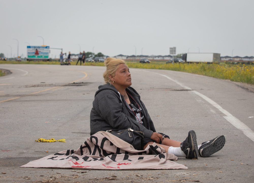 JESSICA LEE / WINNIPEG FREE PRESS
Protestor Melissa Morrisseau sits on the ground Tuesday after the removal of the blockade at Brady Landfill earlier that morning.