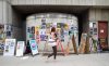 JESSICA LEE / WINNIPEG FREE PRESS
A pedestrian reads posters for the Fringe Festival in the Exchange District.
