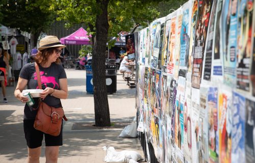 JESSICA LEE / WINNIPEG FREE PRESS
Marianne Morash looks at show listings at the Winnipeg Fringe Festival.